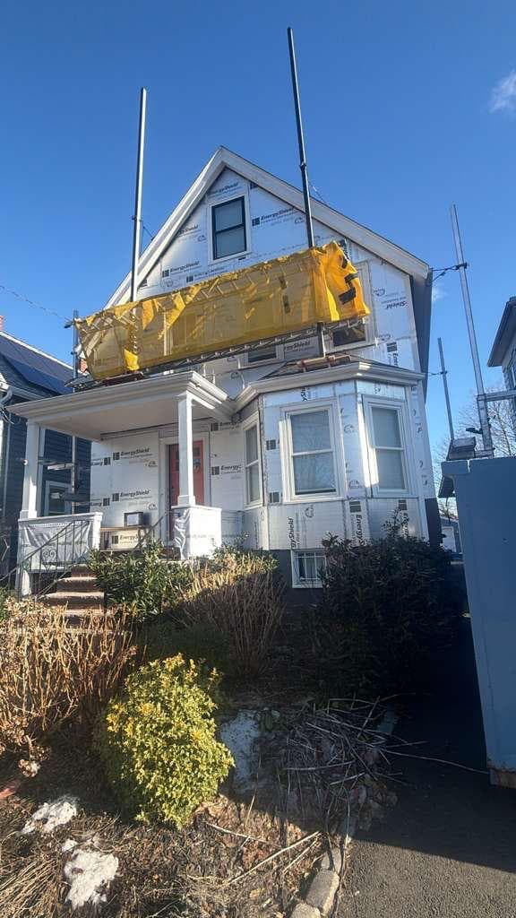 Before — house wrap and scaffolding
